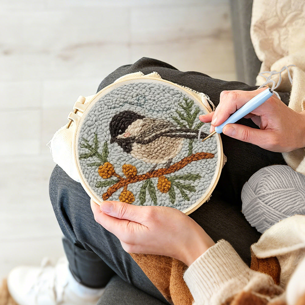Creating handmade chickadee on berry branch punch needle artwork