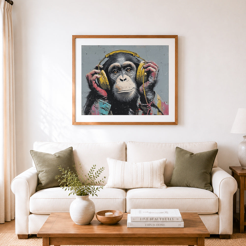 Finished chimp enjoying music cross stitch artwork displayed as home decor