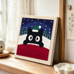Christmas black cat art punch needle artwork displayed on a table