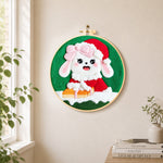 Christmas bunny with gift needle felt wall art displayed in a bright home interior