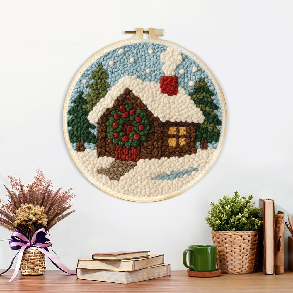 Finished christmas cabin with wreath and smoke artwork displayed on a wall