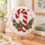 Christmas candy cane embroidery kit finished hoop displayed on a wooden stand as cozy tabletop decor