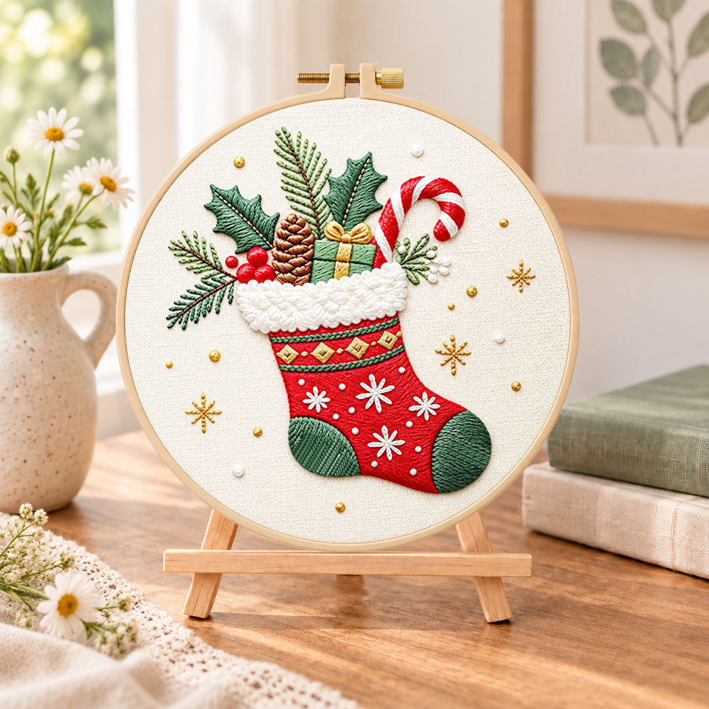 Christmas fireplace stocking embroidery kit finished hoop displayed on a wooden stand as cozy tabletop decor
