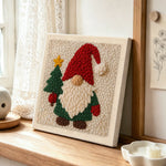 Christmas gnome and tree punch needle artwork displayed on a table