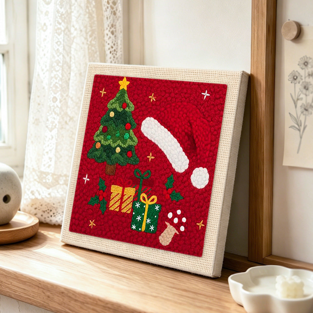 Christmas hat and gifts punch needle artwork displayed on a table