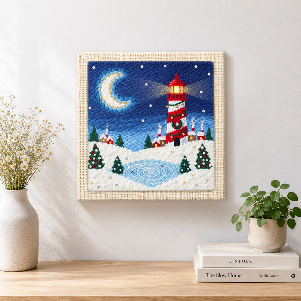 Finished christmas lighthouse scene artwork displayed on a wall