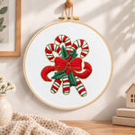 Christmas striped candy cane embroidery hoop wall art displayed as warm and cozy handmade home decor