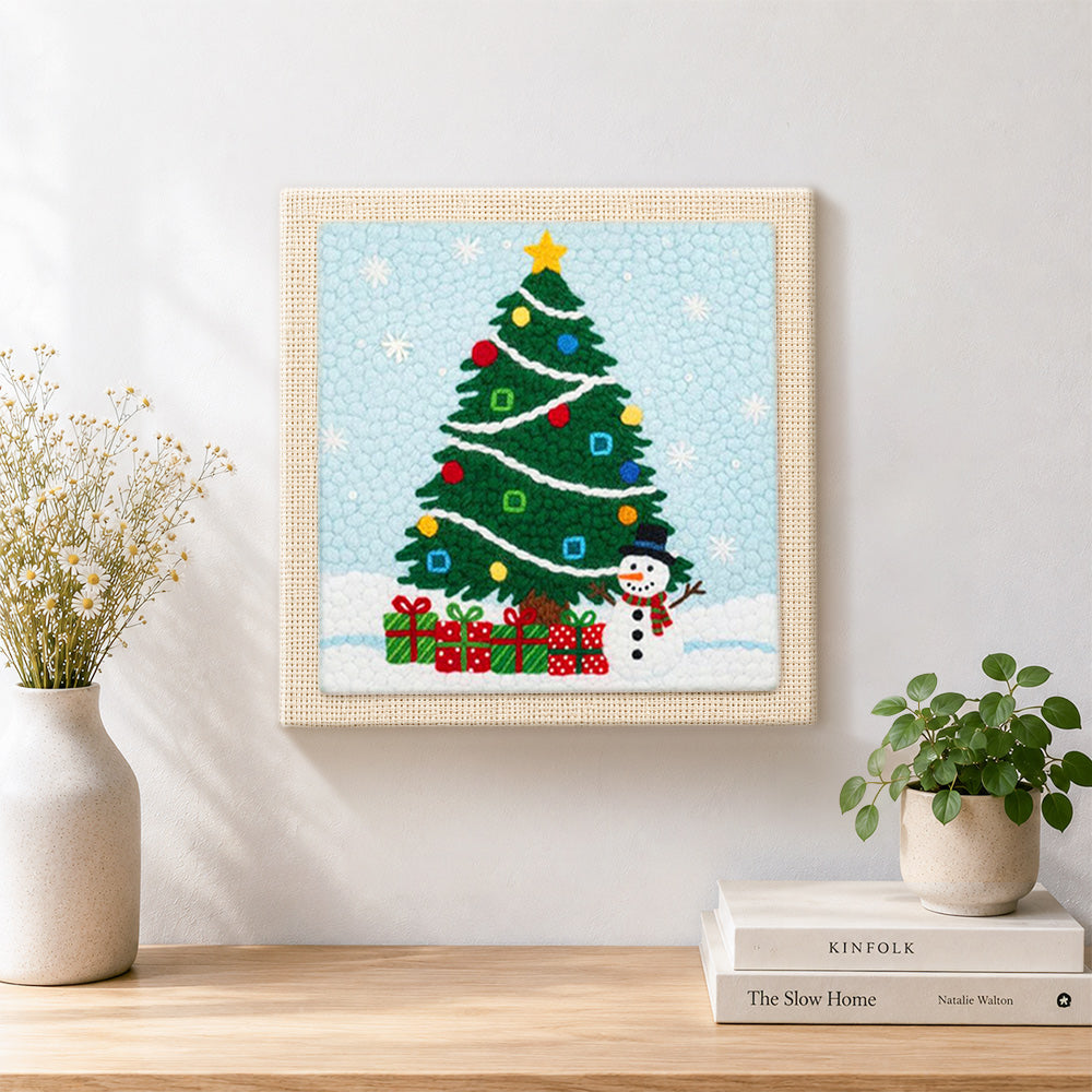 Finished christmas tree and snowman artwork displayed on a wall