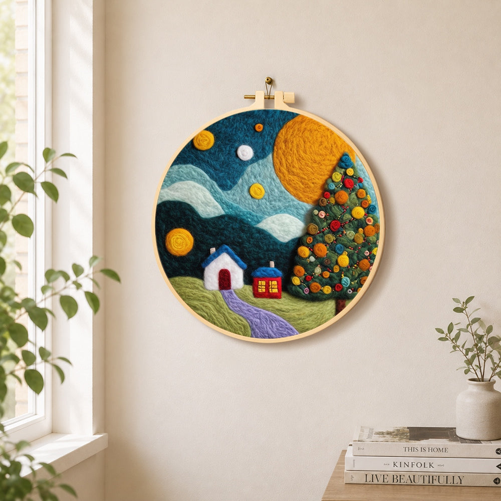 Christmas tree and winter village needle felt wall art displayed in a bright home interior
