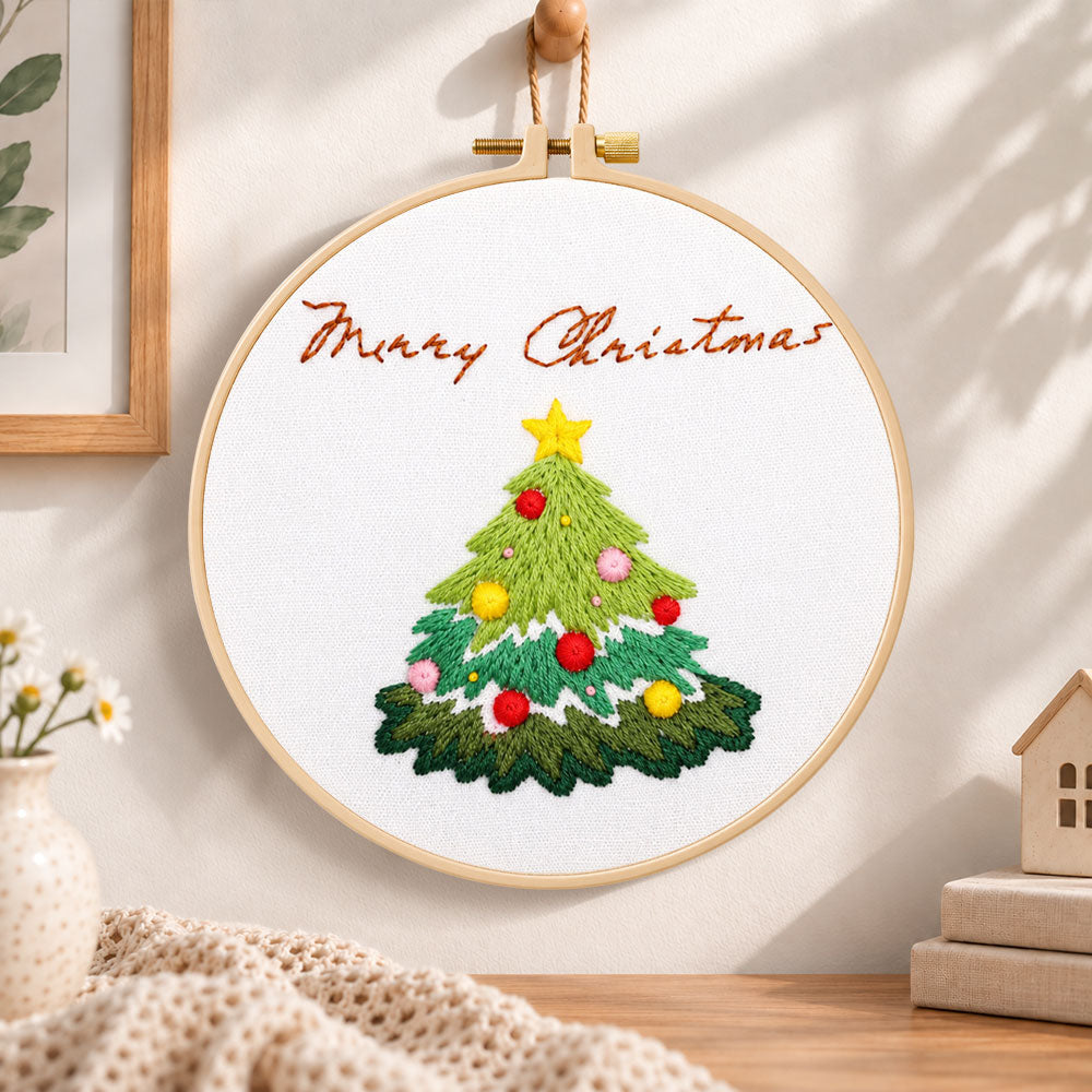 Christmas tree greeting embroidery hoop wall art displayed as warm and cozy handmade home decor