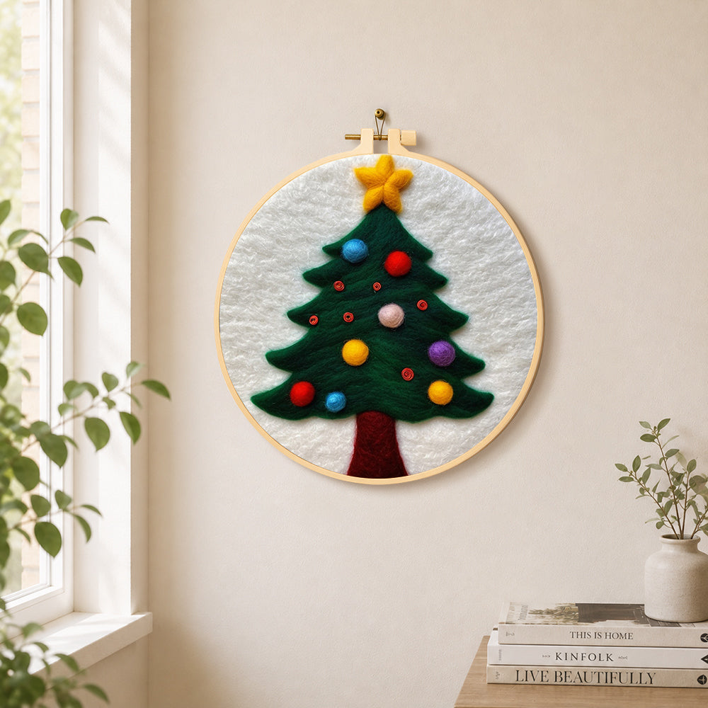 Christmas tree with colorful baubles needle felt wall art displayed in a bright home interior