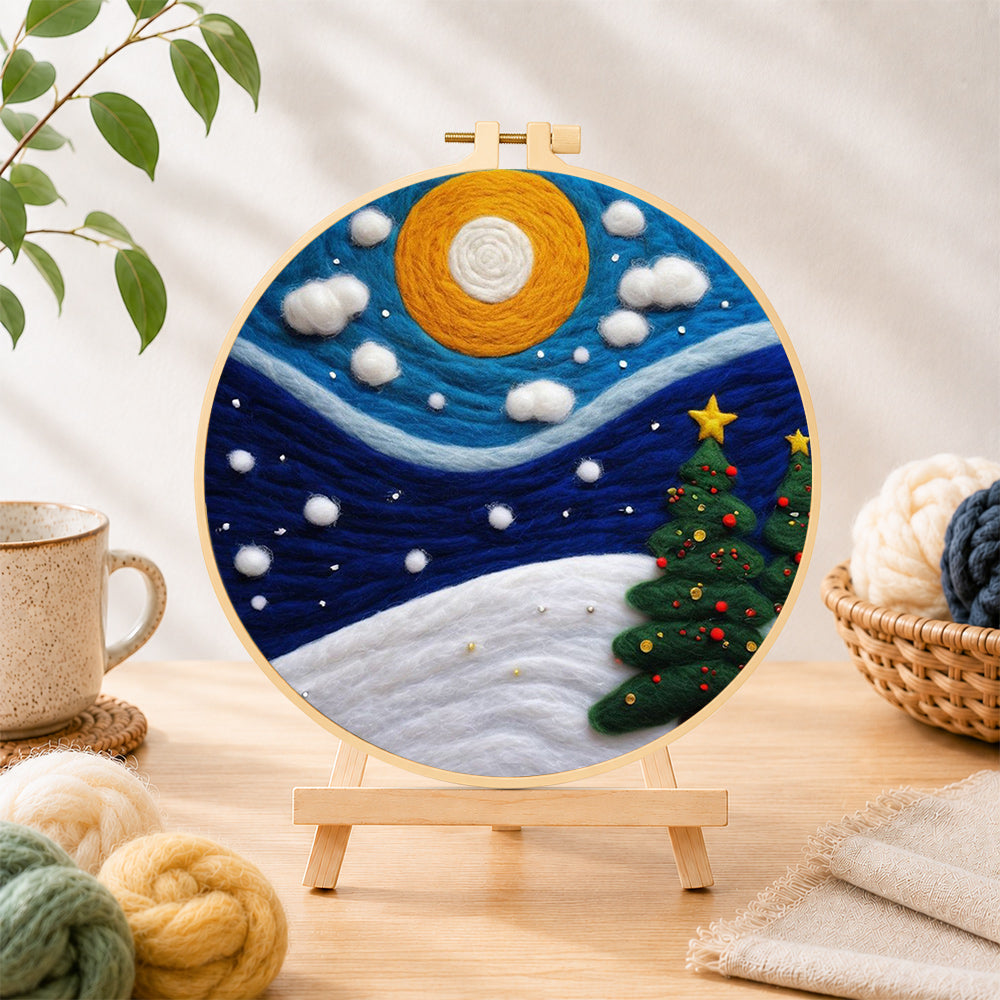 Finished christmas trees under the moon needle felting displayed on a wooden easel