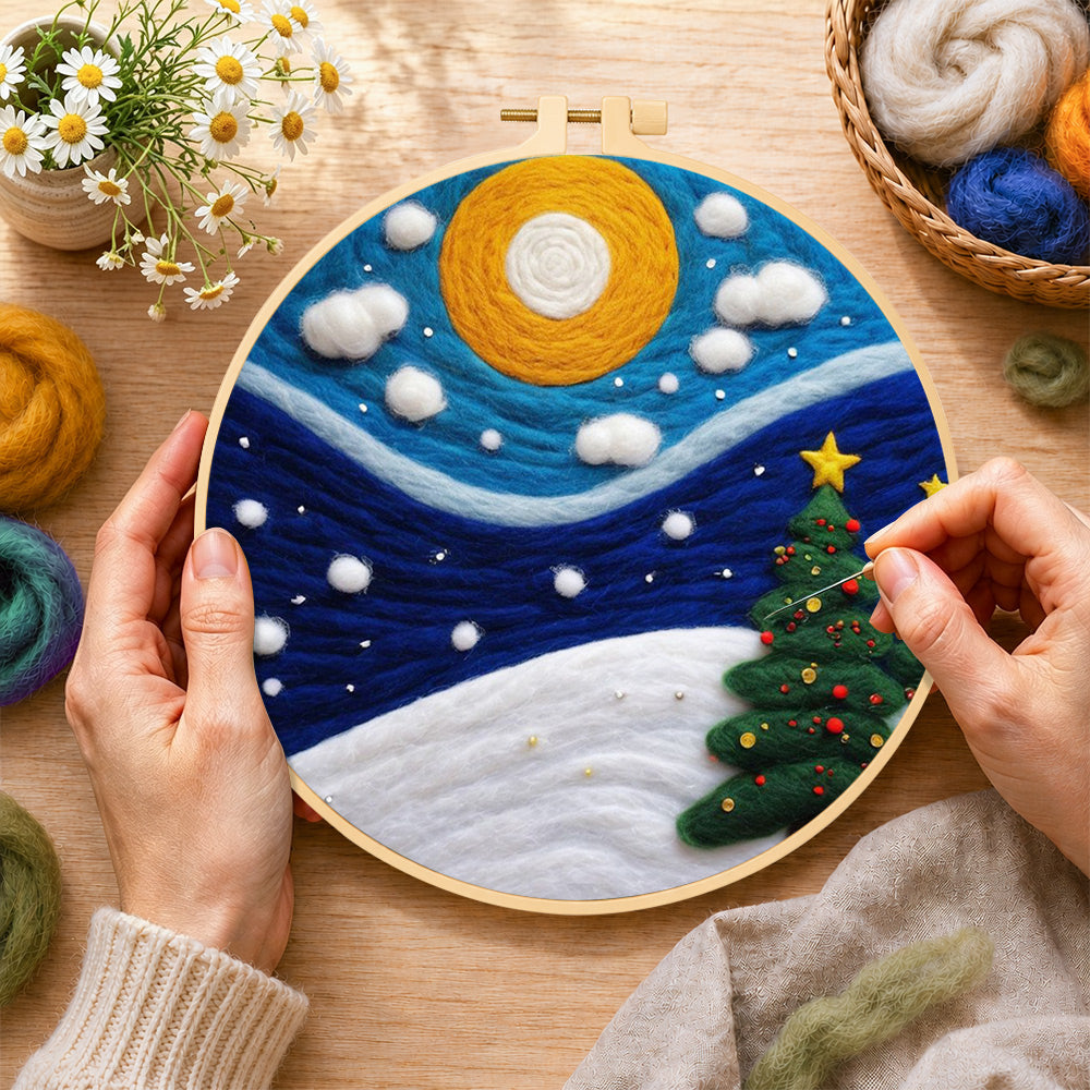 Creating the christmas trees under the moon wool painting by hand with a felting needle