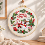 Christmas wreath scene embroidery hoop wall art displayed as warm and cozy handmade home decor