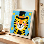 Circus tiger with stars and hat punch needle artwork displayed on a table