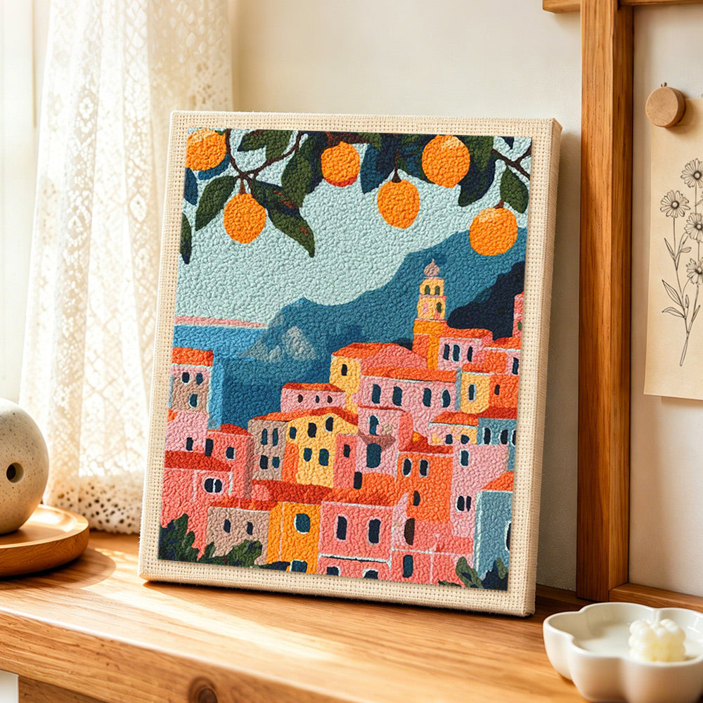 Citrus coastal town punch needle artwork displayed on a table