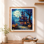 Finished classic spooky mansion cross stitch artwork displayed as home decor
