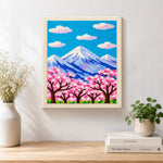 Finished cloudy sakura mountain artwork displayed on a wall