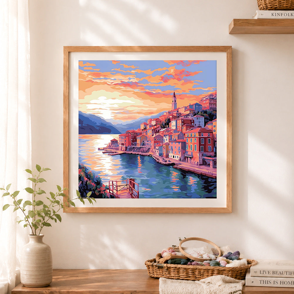 Finished coastal mediterranean town cross stitch artwork displayed as home decor