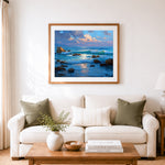 Finished coastal ocean sunset cross stitch artwork displayed as home decor