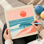 Creating handmade coastal surfer and peach sunset scene punch needle artwork