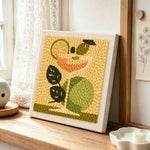 Cocktail with green leaves and lime punch needle artwork displayed on a table