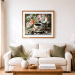 Finished coffee cup with spring blooms cross stitch artwork displayed as home decor