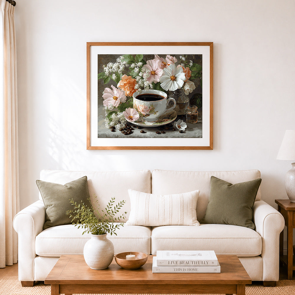Finished coffee cup with spring blooms cross stitch artwork displayed as home decor