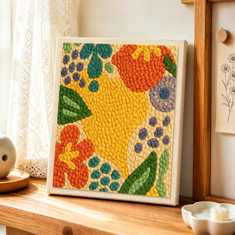 Colorful abstract botanical punch needle artwork displayed on a table