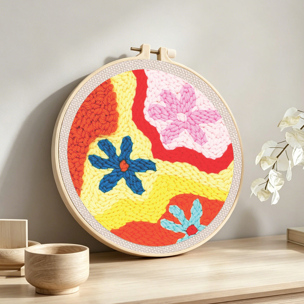 Colorful abstract flowers punch needle artwork displayed on a table