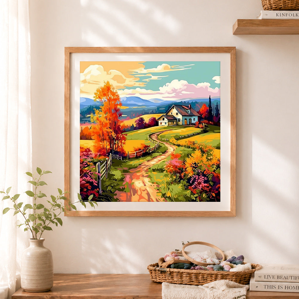 Finished colorful autumn farm house cross stitch artwork displayed as home decor