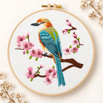 Colorful bird amid pink cherry blossoms embroidery kit