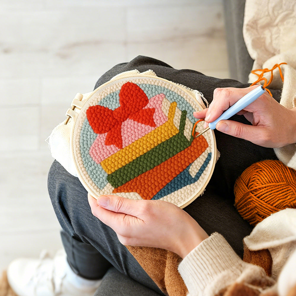 Creating handmade colorful book stack with bow punch needle artwork