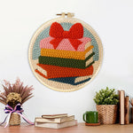 Finished colorful book stack with bow artwork displayed on a wall