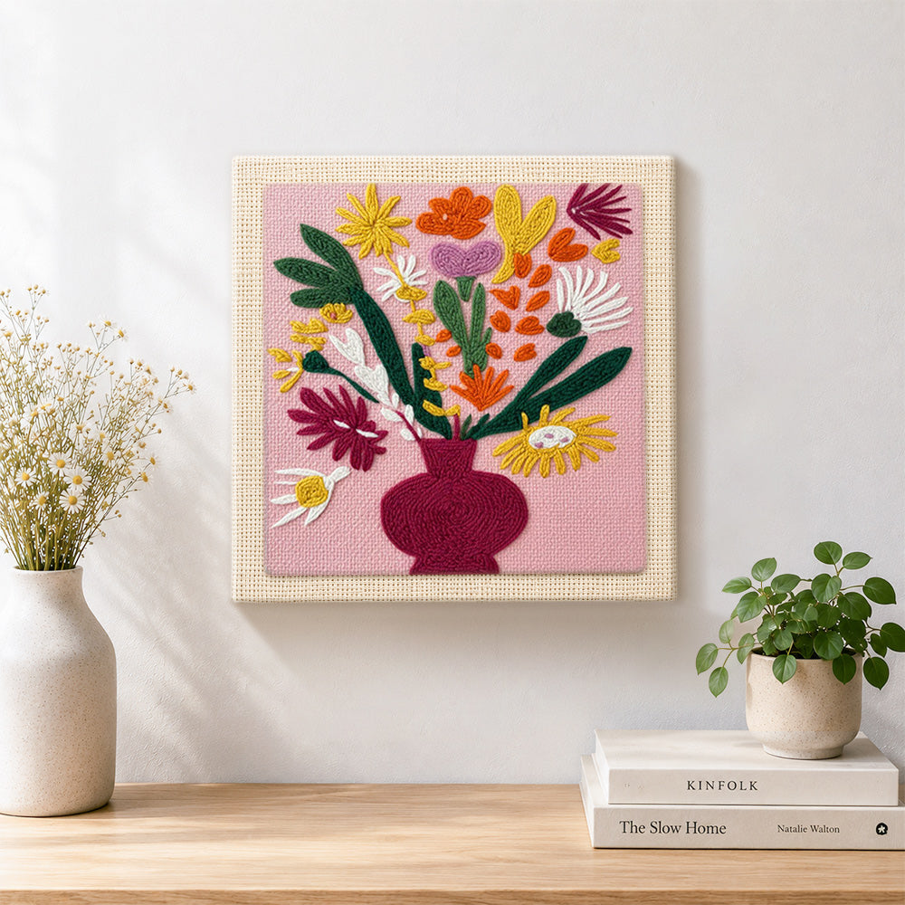 Finished colorful bouquet in burgundy vase artwork displayed on a wall