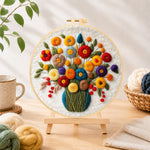 Finished colorful bouquet with berries needle felting displayed on a wooden easel