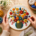 Creating the colorful bouquet with berries wool painting by hand with a felting needle
