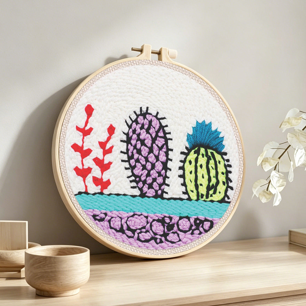 Colorful cactus trio punch needle artwork displayed on a table