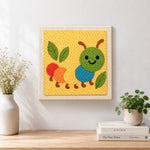 Finished colorful caterpillar artwork displayed on a wall
