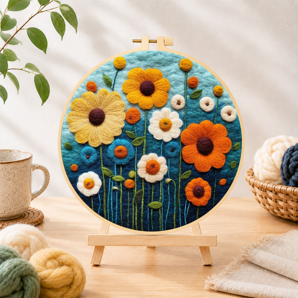 Finished colorful daisies on dark blue needle felting displayed on a wooden easel