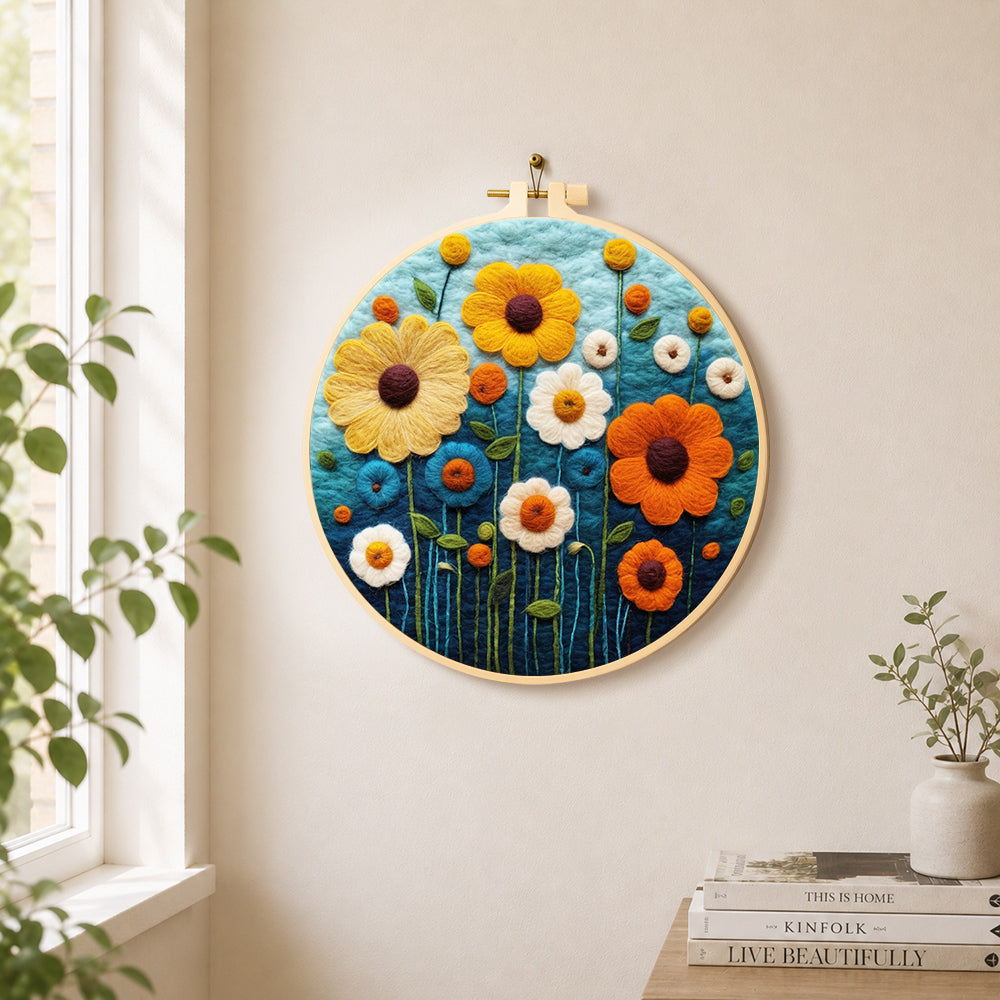 Colorful daisies on dark blue needle felt wall art displayed in a bright home interior