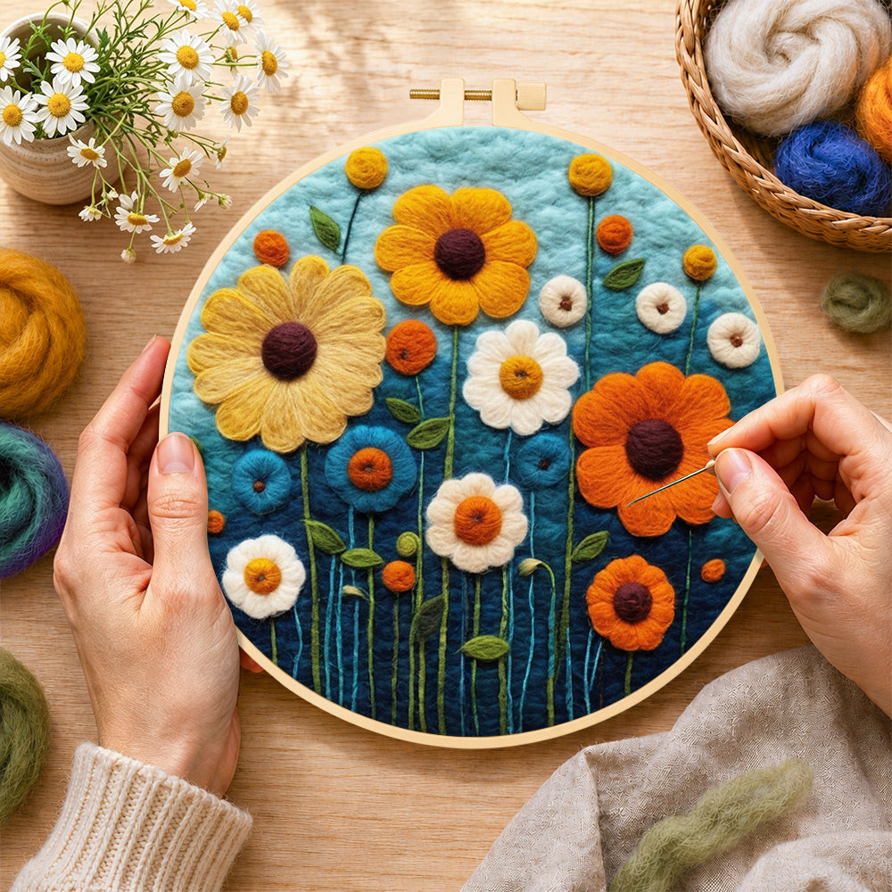 Creating the colorful daisies on dark blue wool painting by hand with a felting needle