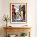 Finished colorful european village street with church cross stitch artwork displayed as home decor