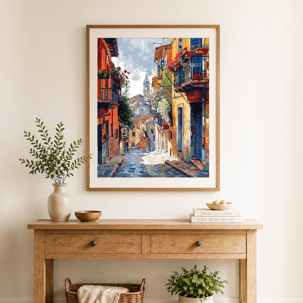Finished colorful european village street with church cross stitch artwork displayed as home decor
