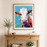 Finished colorful farm cow cross stitch artwork displayed as home decor