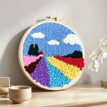Colorful floral field punch needle artwork displayed on a table
