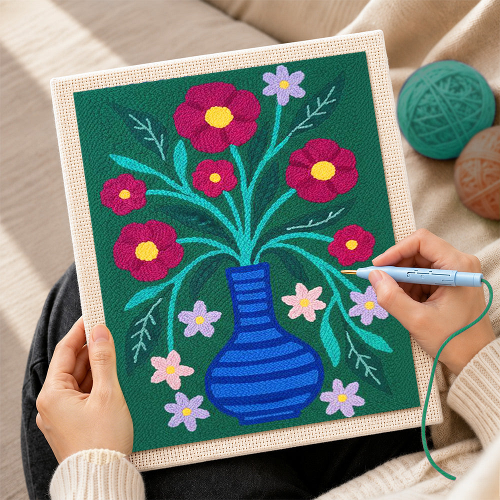 Creating handmade colorful flowers in striped blue vase punch needle artwork