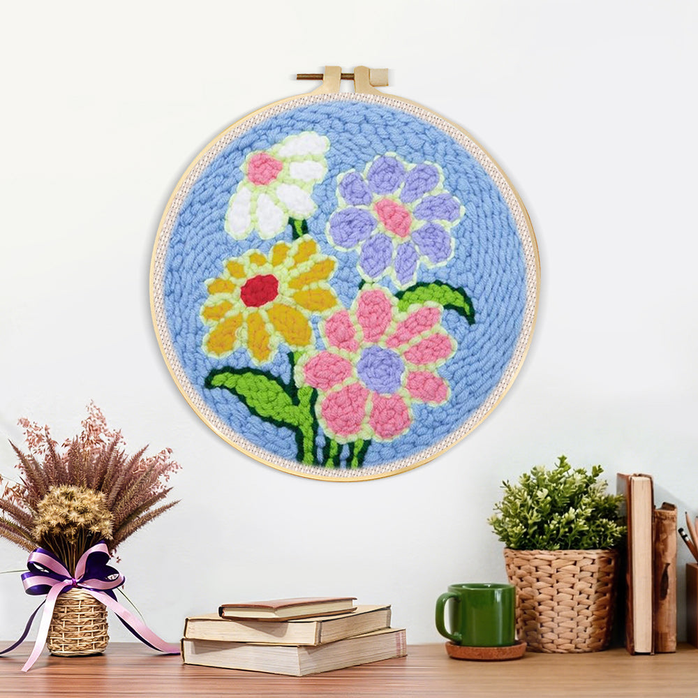 Finished colorful flowers on blue-background artwork displayed on a wall