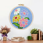 Finished colorful flowers on blue-background artwork displayed on a wall