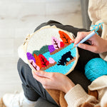Creating handmade colorful forest above a lake punch needle artwork